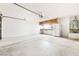Spacious garage with ample storage, workbench, and water heater at 4324 Peaceful Path Ct, North Las Vegas, NV 89032