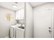 Well-lit laundry room with front loading washer and dryer at 4324 Peaceful Path Ct, North Las Vegas, NV 89032