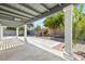 Covered patio with white support beams, concrete floor and desert landscape at 4324 Peaceful Path Ct, North Las Vegas, NV 89032