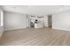 Spacious living area with open floor plan, wood-look floors, and a view of the kitchen and hallways at 4433 Pioche Ave, North Las Vegas, NV 89032