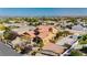 Expansive aerial view of a tan home with a terracotta roof and a gated driveway at 4620 N Tee Pee Ln, Las Vegas, NV 89129