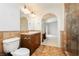 This bathroom features a spacious design with an arched doorway, glass shower, and vanity at 4620 N Tee Pee Ln, Las Vegas, NV 89129
