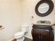 Elegant powder room with ornate mirror and granite countertop at 4620 N Tee Pee Ln, Las Vegas, NV 89129