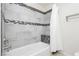 Bathroom featuring decorative tile surround, showerhead, and seat inside tiled shower at 4620 N Tee Pee Ln, Las Vegas, NV 89129