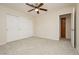 Neutral bedroom featuring carpeted floors, ceiling fan, and closet for ample storage at 4620 N Tee Pee Ln, Las Vegas, NV 89129