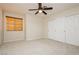 Cozy bedroom featuring window, carpet, and double door closet at 4620 N Tee Pee Ln, Las Vegas, NV 89129