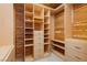 Walk-in closet with custom wood organizers, built-in shelves, and drawers for optimal storage at 4620 N Tee Pee Ln, Las Vegas, NV 89129