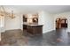 Bright dining room with chandelier, stone floors, and view into the kitchen at 4620 N Tee Pee Ln, Las Vegas, NV 89129