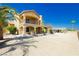 Two-story home with a balcony, spiral staircase, drought tolerant landscaping, and outbuildings at 4620 N Tee Pee Ln, Las Vegas, NV 89129