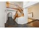 Open foyer with wood staircase, stone floors, and arched doorways leading to other rooms in the house at 4620 N Tee Pee Ln, Las Vegas, NV 89129