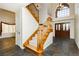 Bright foyer with wood staircase and double-door entryway that create a welcoming space at 4620 N Tee Pee Ln, Las Vegas, NV 89129