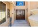 Elegant double front doors with decorative glass, framed by pillars and decorative lighting fixtures at 4620 N Tee Pee Ln, Las Vegas, NV 89129