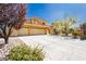 Spacious home featuring a three-car garage, desert landscaping, and a well-maintained front yard at 4620 N Tee Pee Ln, Las Vegas, NV 89129