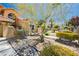 Lovely home featuring desert landscaping with rocks, plants and desert trees at 4620 N Tee Pee Ln, Las Vegas, NV 89129