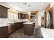Modern kitchen featuring stainless steel appliances, dark cabinets, and granite countertops at 4620 N Tee Pee Ln, Las Vegas, NV 89129