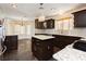Spacious kitchen with granite countertops, dark cabinetry and tile floors at 4620 N Tee Pee Ln, Las Vegas, NV 89129