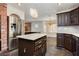 Open concept kitchen with granite island and stainless steel refrigerator at 4620 N Tee Pee Ln, Las Vegas, NV 89129