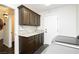Neutral laundry room with granite countertops and cabinetry at 4620 N Tee Pee Ln, Las Vegas, NV 89129