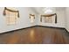 Open living area with hardwood floors, decorative window coverings, and arched windows at 4620 N Tee Pee Ln, Las Vegas, NV 89129
