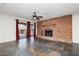 Cozy living room featuring a brick fireplace and a sliding door, with tile floors at 4620 N Tee Pee Ln, Las Vegas, NV 89129