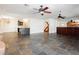 Open living area with kitchen view, ceiling fans, and stone flooring, great for entertaining at 4620 N Tee Pee Ln, Las Vegas, NV 89129