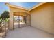 Covered patio featuring concrete floors, an ornate security gate, and desert views at 4620 N Tee Pee Ln, Las Vegas, NV 89129