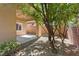 This backyard features desert landscaping with a covered patio and block wall in the background at 5603 Deer Creek Falls Ct, Las Vegas, NV 89118
