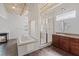Modern bathroom with a soaking tub, shower, dual vanities and a decorative fireplace at 5603 Deer Creek Falls Ct, Las Vegas, NV 89118