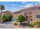 Charming townhouse featuring neutral stucco facade, private balcony, garage and mature landscaping at 5603 Deer Creek Falls Ct, Las Vegas, NV 89118