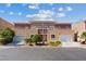 Attractive two-story townhome with a stucco exterior, balconies, and well-manicured landscaping at 5603 Deer Creek Falls Ct, Las Vegas, NV 89118