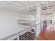 Hallway with wood floors, steel railings and exposed ceiling beams at 5603 Deer Creek Falls Ct, Las Vegas, NV 89118