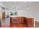 Open concept space with island in the kitchen and steel beam ceiling at 5603 Deer Creek Falls Ct, Las Vegas, NV 89118
