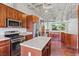 Contemporary kitchen with granite countertops, stainless steel appliances, and cherry wood cabinetry at 5603 Deer Creek Falls Ct, Las Vegas, NV 89118