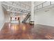 Open-concept living space with high ceilings, a fireplace, and stairs leading to a loft area at 5603 Deer Creek Falls Ct, Las Vegas, NV 89118