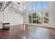 Spacious living room with concrete floors, fireplace, balcony, and large windows with views of the backyard at 5603 Deer Creek Falls Ct, Las Vegas, NV 89118