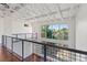 Spacious living room with exposed beams, large windows and hardwood floors at 5603 Deer Creek Falls Ct, Las Vegas, NV 89118