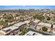 An aerial view showcases the neighborhood with mature trees and lush landscaping with city views at 5603 Deer Creek Falls Ct, Las Vegas, NV 89118
