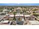 An aerial view displays an expansive neighborhood with lush trees, mature landscaping and stunning mountain views at 5603 Deer Creek Falls Ct, Las Vegas, NV 89118