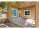 This covered patio features a concrete base with a view of the landscaped yard with a door leading inside at 5603 Deer Creek Falls Ct, Las Vegas, NV 89118