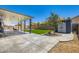 Entertaining backyard with pool view, covered patio, fresh green grass and desert landscaping at 5660 Oasis Ridge St, North Las Vegas, NV 89031