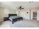 Large bedroom with neutral carpet, ceiling fan, closet, and access to other rooms at 5660 Oasis Ridge St, North Las Vegas, NV 89031