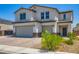 Inviting two-story home featuring a two-car garage and charming desert landscaping at 5660 Oasis Ridge St, North Las Vegas, NV 89031