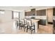 Well-appointed kitchen featuring a center island with seating and stainless steel appliances at 5660 Oasis Ridge St, North Las Vegas, NV 89031