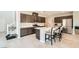 Modern kitchen features stainless steel appliances, island with seating, and ample cabinet space at 5660 Oasis Ridge St, North Las Vegas, NV 89031