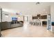 Open-concept living space with tiled floors, ceiling fan, seamlessly connecting living area and kitchen at 5660 Oasis Ridge St, North Las Vegas, NV 89031