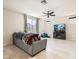 Bright living room with tiled floor, ceiling fan, and large window with views to the outside at 5660 Oasis Ridge St, North Las Vegas, NV 89031