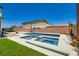 Sparkling in-ground pool and spa with surrounding concrete and view of the house at 5660 Oasis Ridge St, North Las Vegas, NV 89031