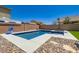 Beautiful in-ground pool with hot tub and basketball hoop in a well-landscaped backyard at 5660 Oasis Ridge St, North Las Vegas, NV 89031