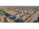 A high-angle view showcasing an extensive community of townhouses with red tile roofs in an organized street layout at 5855 Valley Dr # 2145, North Las Vegas, NV 89031