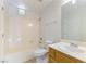 Bright bathroom features a tub/shower combo, white toilet, and wood vanity with ample storage space at 5855 Valley Dr # 2145, North Las Vegas, NV 89031
